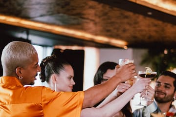 a group of people holding glasses of drinks