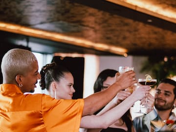 a group of people holding glasses of drinks