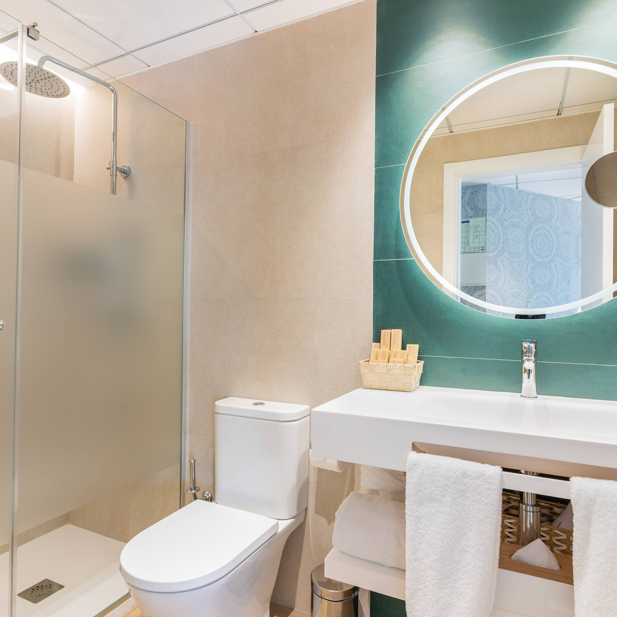 a bathroom with a round mirror and a sink