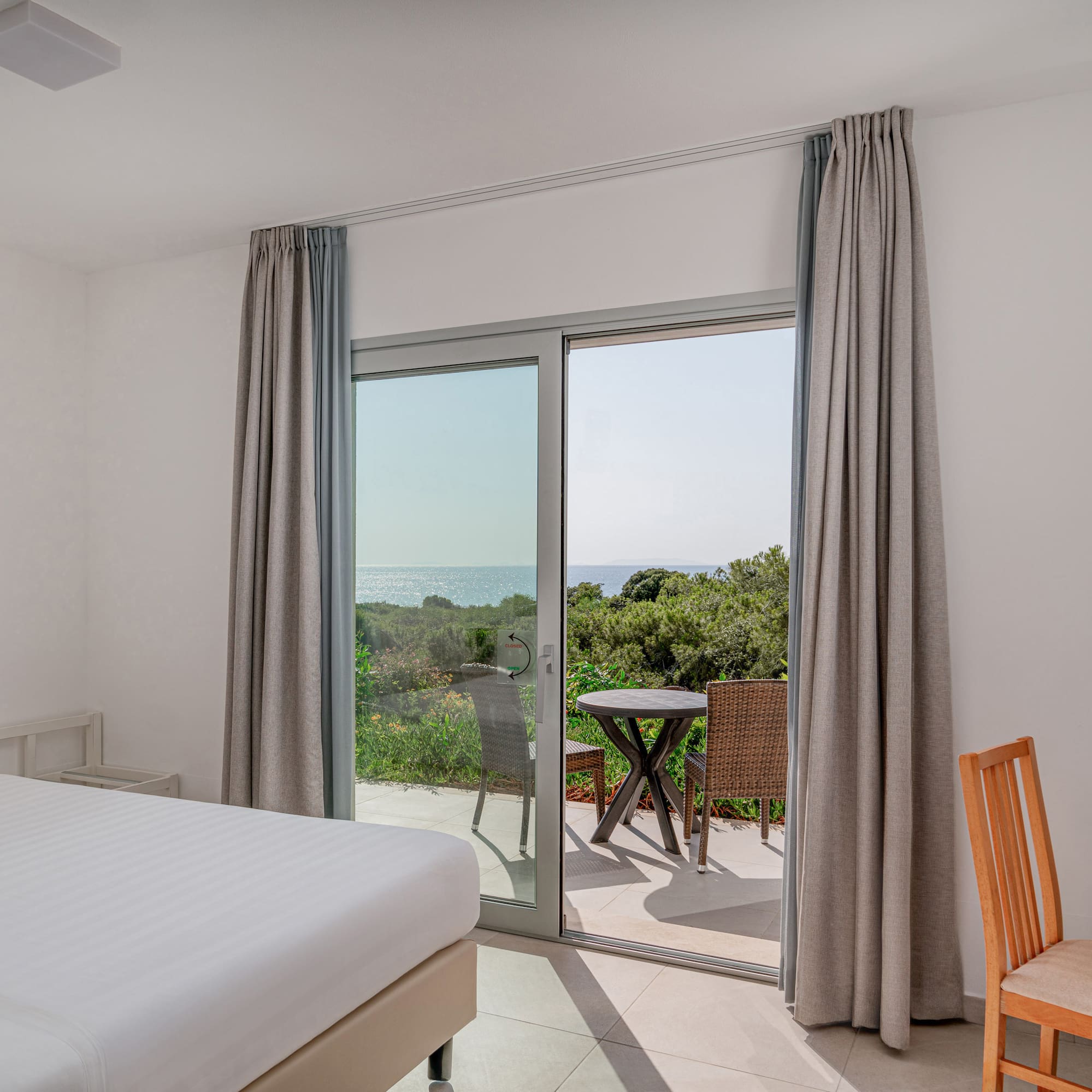 a room with a bed and a glass door