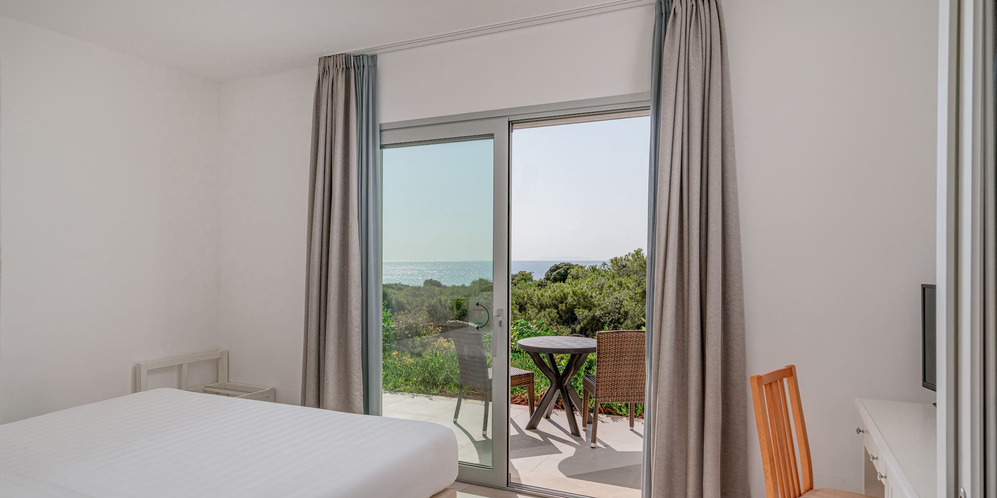 a room with a bed and a glass door