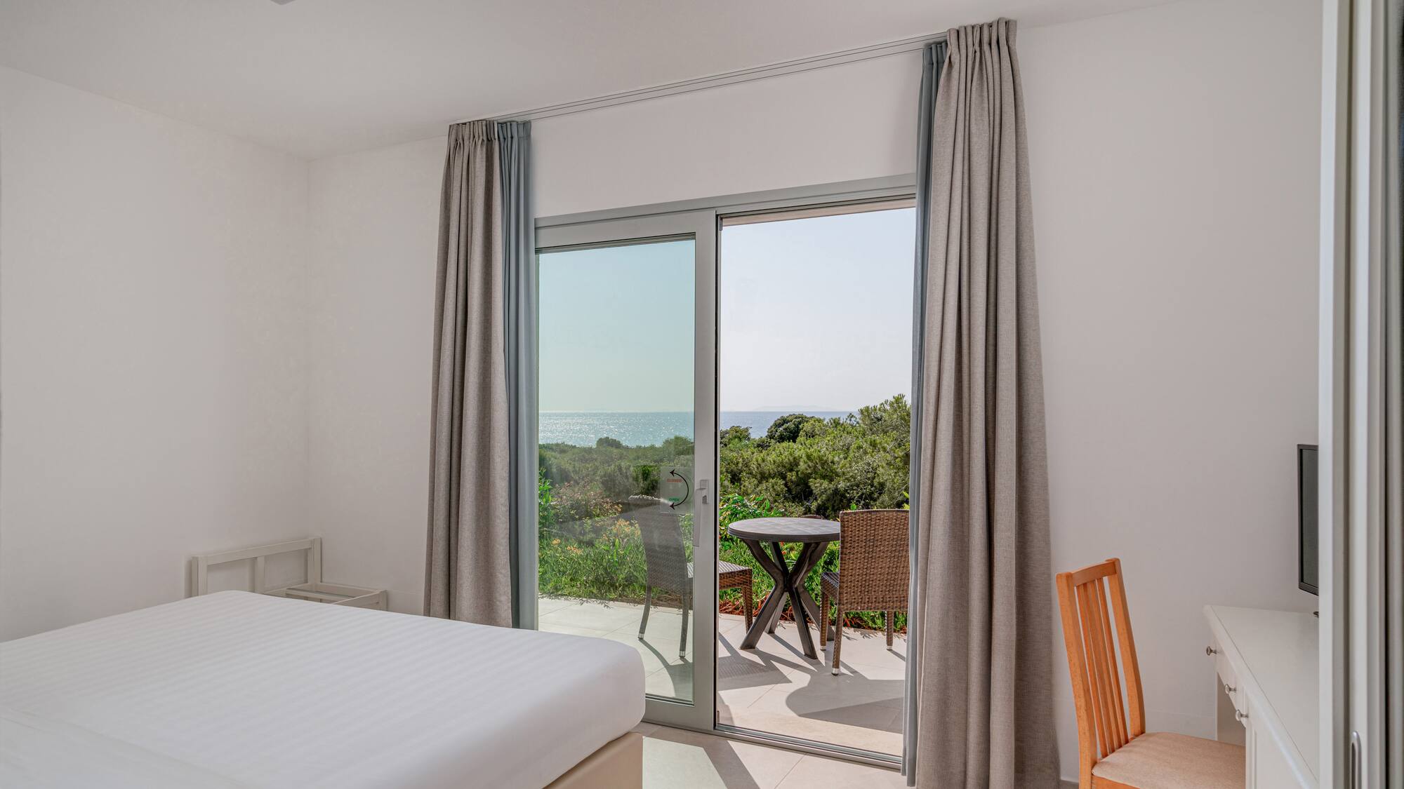 a room with a bed and a glass door