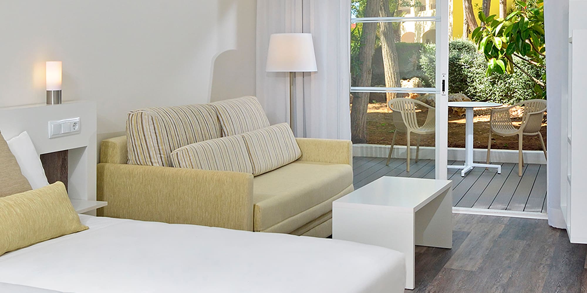 a room with two beds and a couch