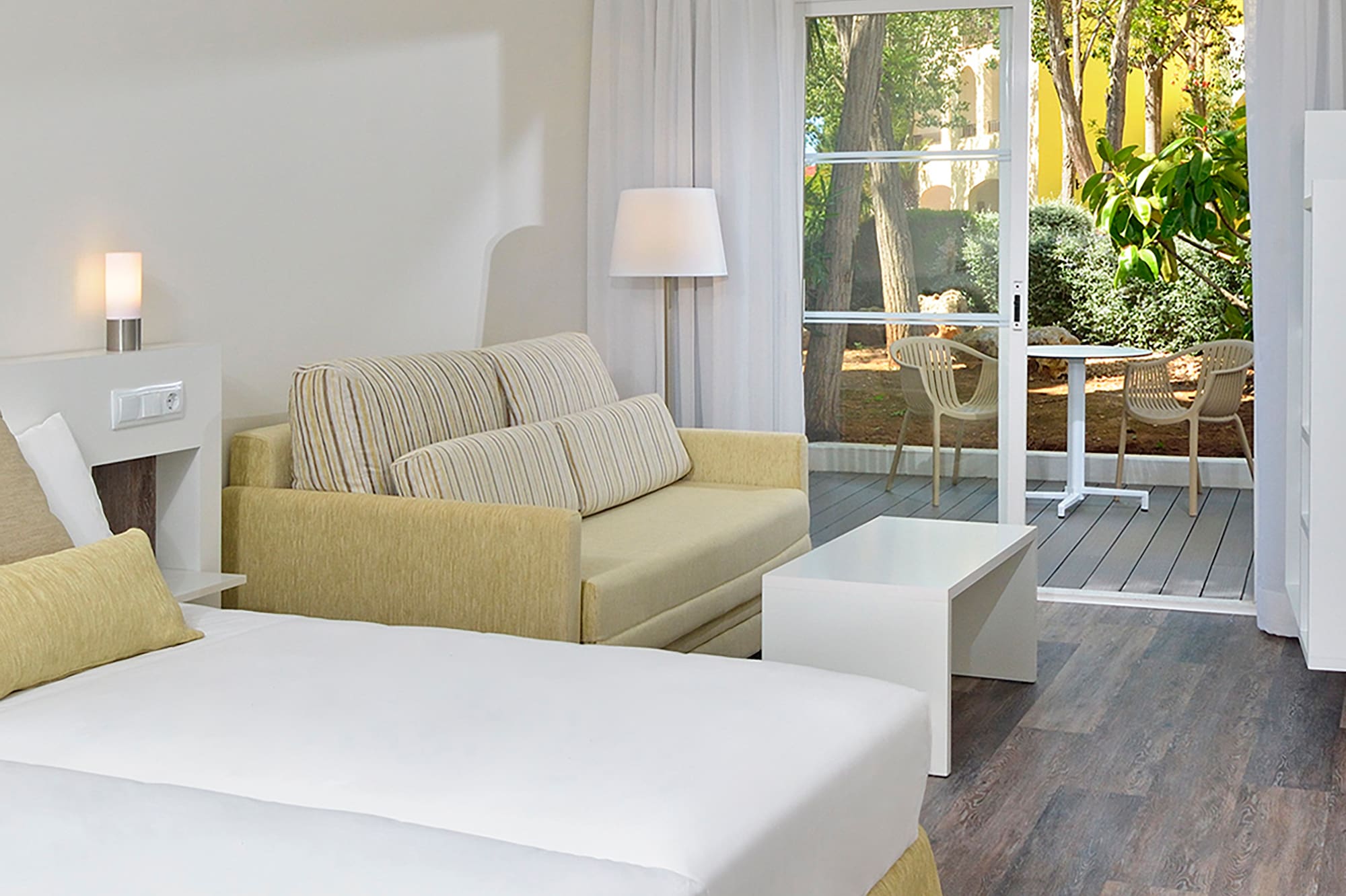 a room with two beds and a couch