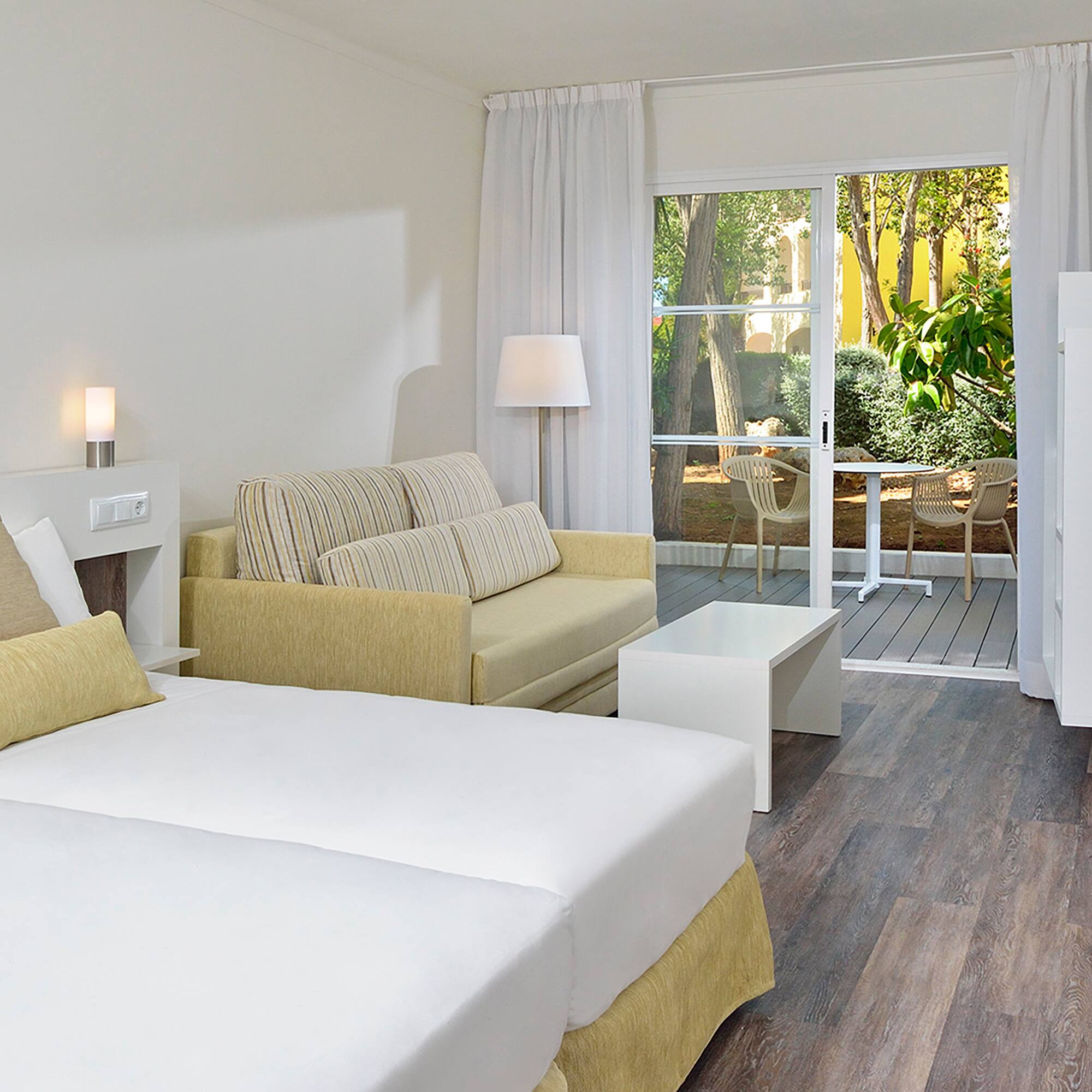 a room with two beds and a couch