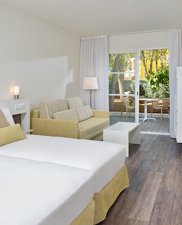 a room with two beds and a couch