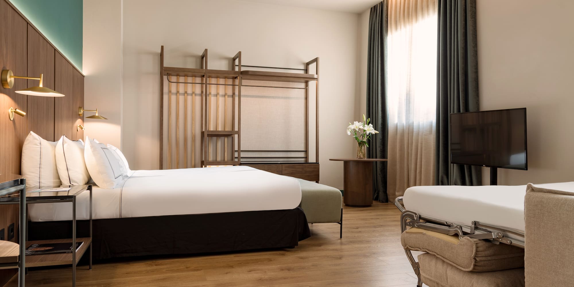 a room with two beds and a tv