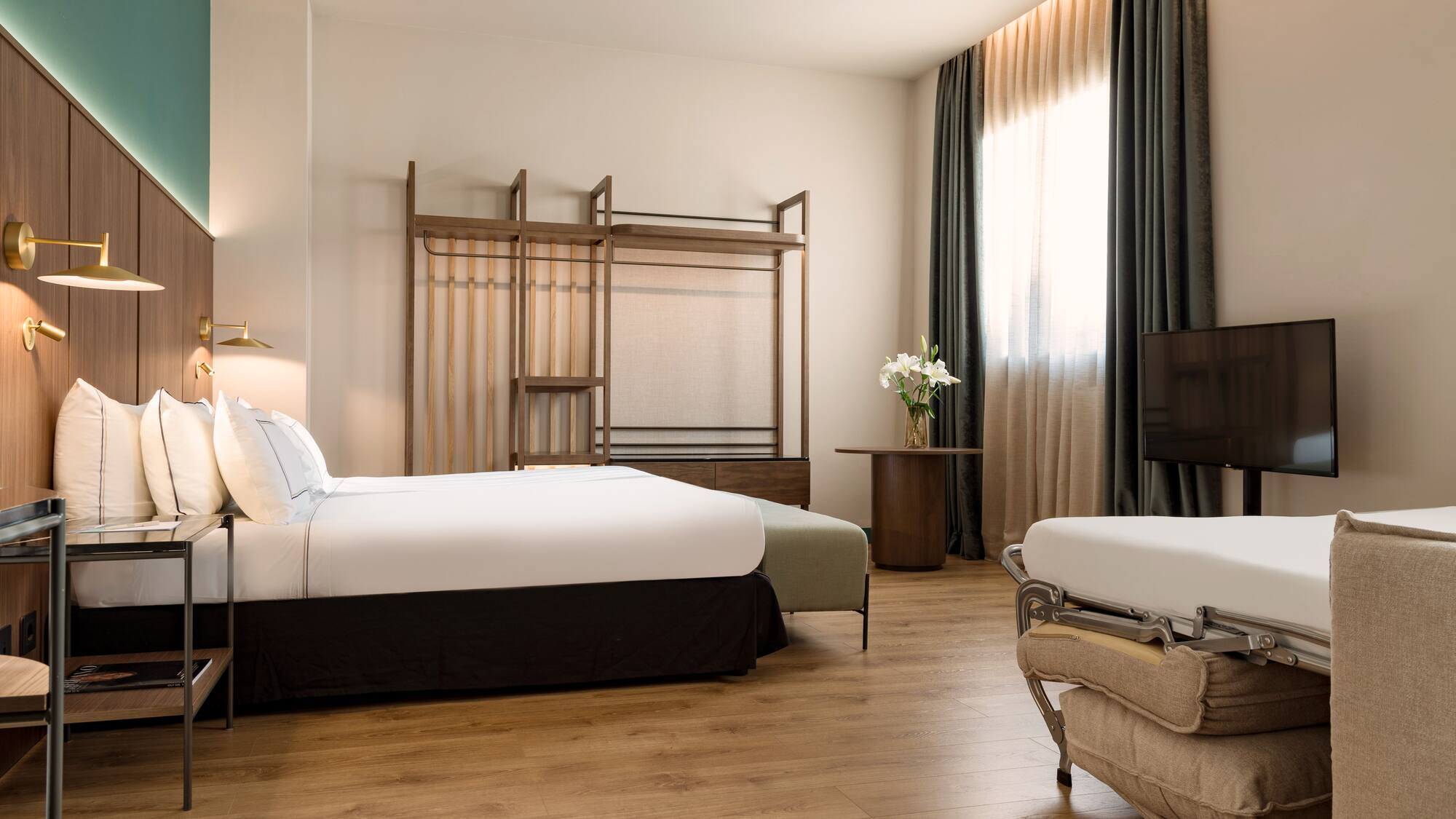 a room with two beds and a tv