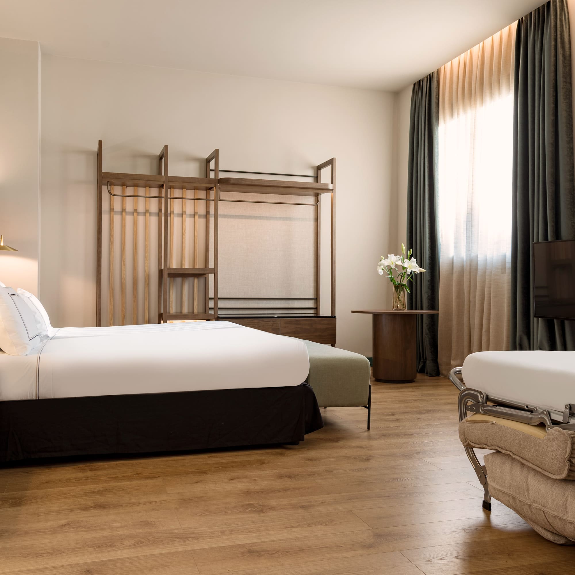 a room with two beds and a tv