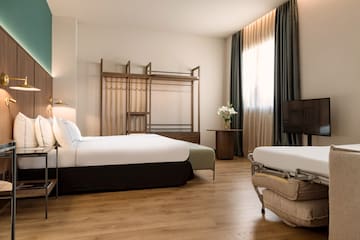 a room with two beds and a tv