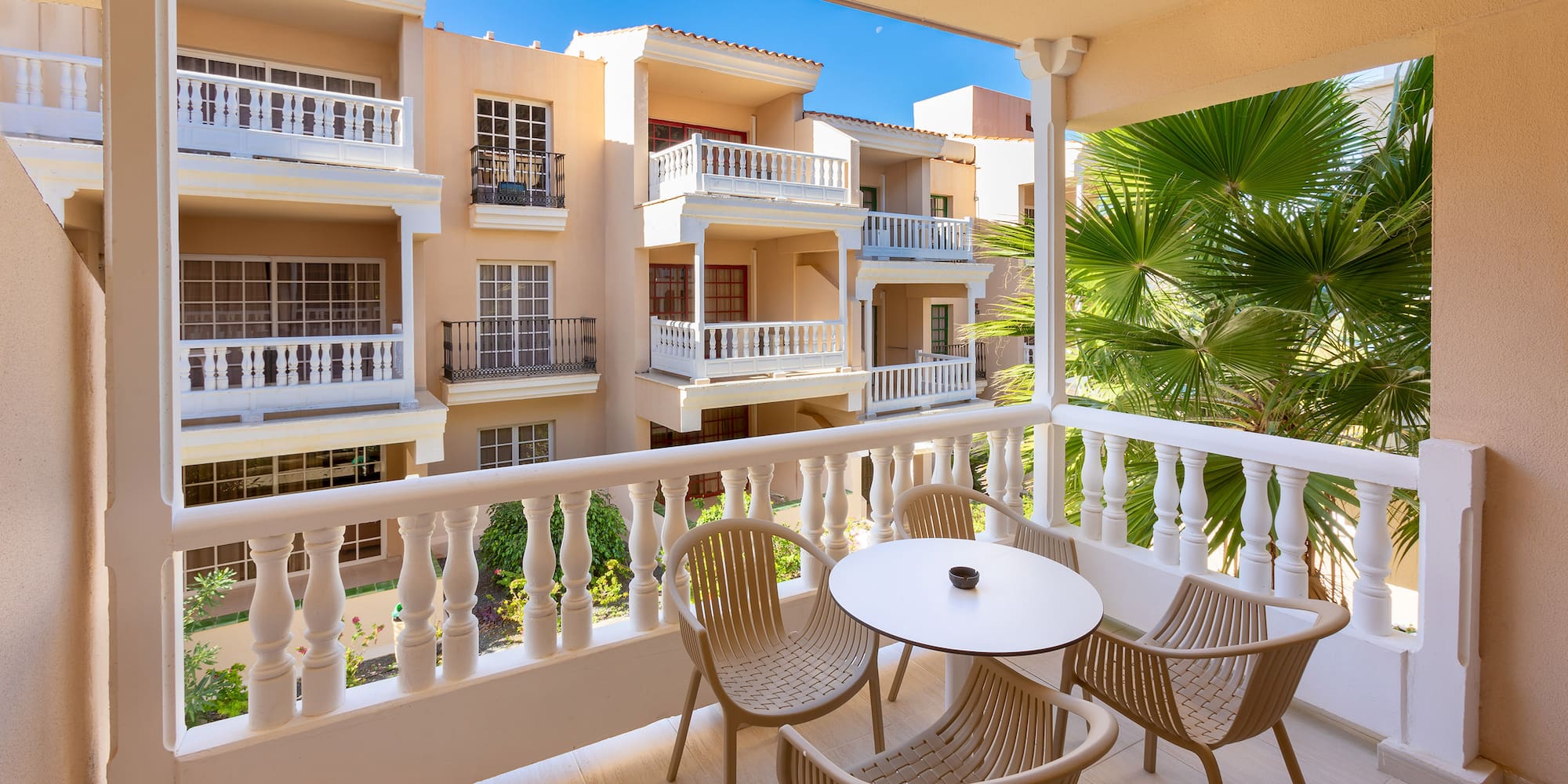 a balcony with chairs and tables