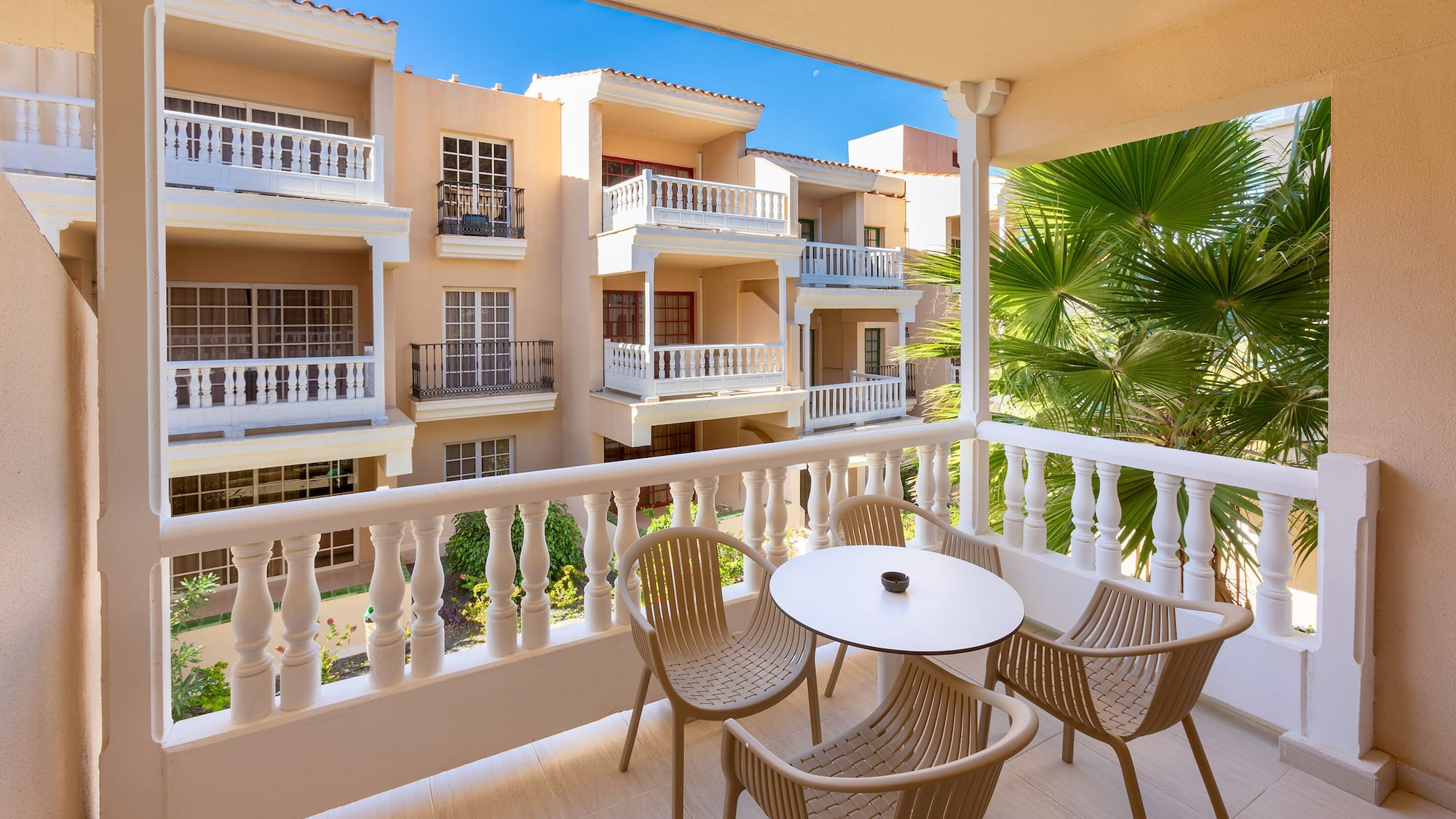 a balcony with chairs and tables