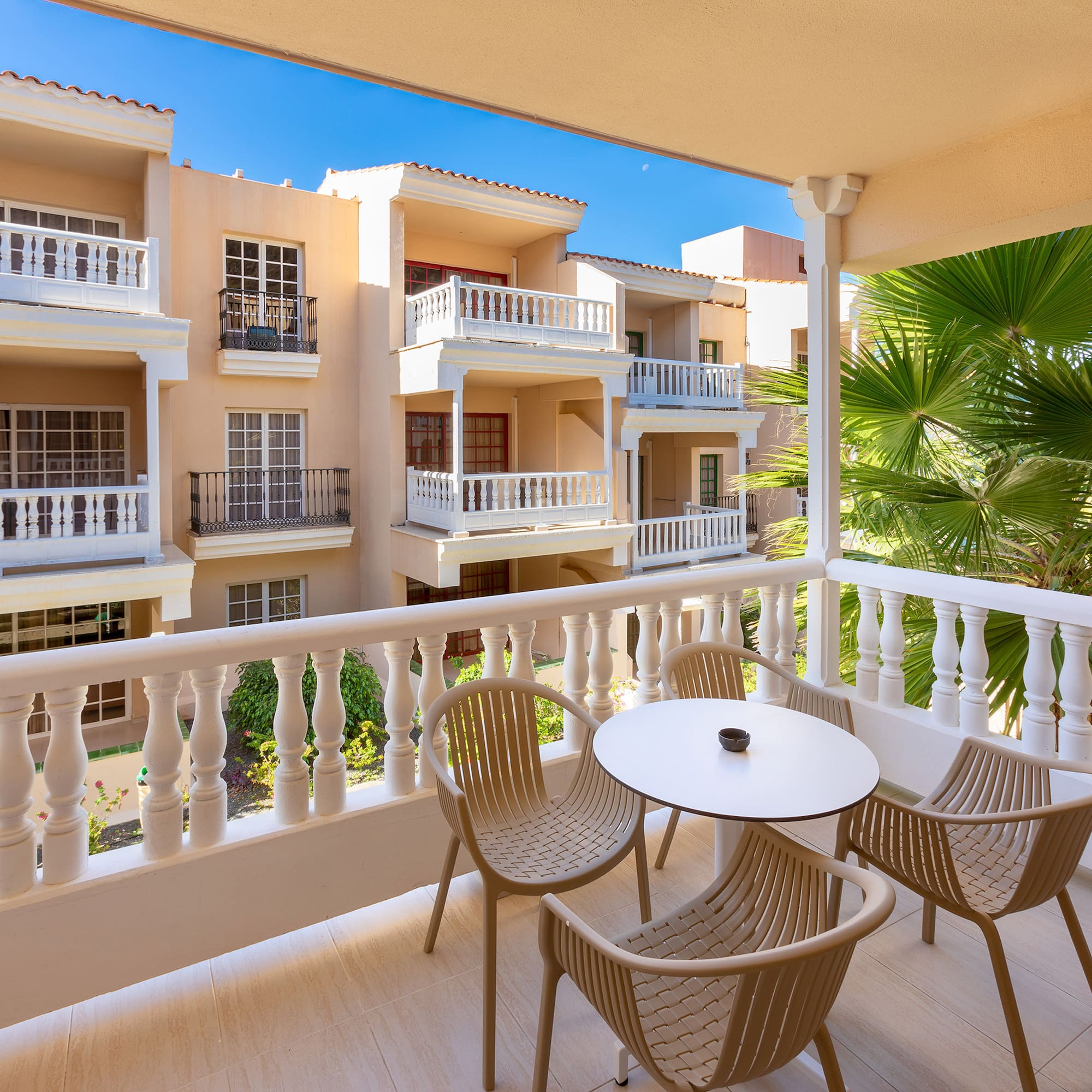 a balcony with chairs and tables