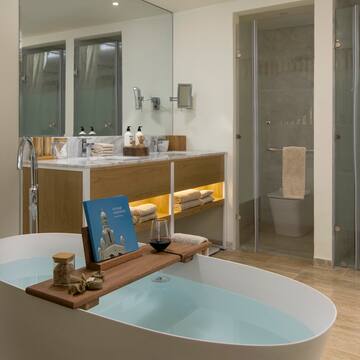 a bathroom with a tub and a glass shower