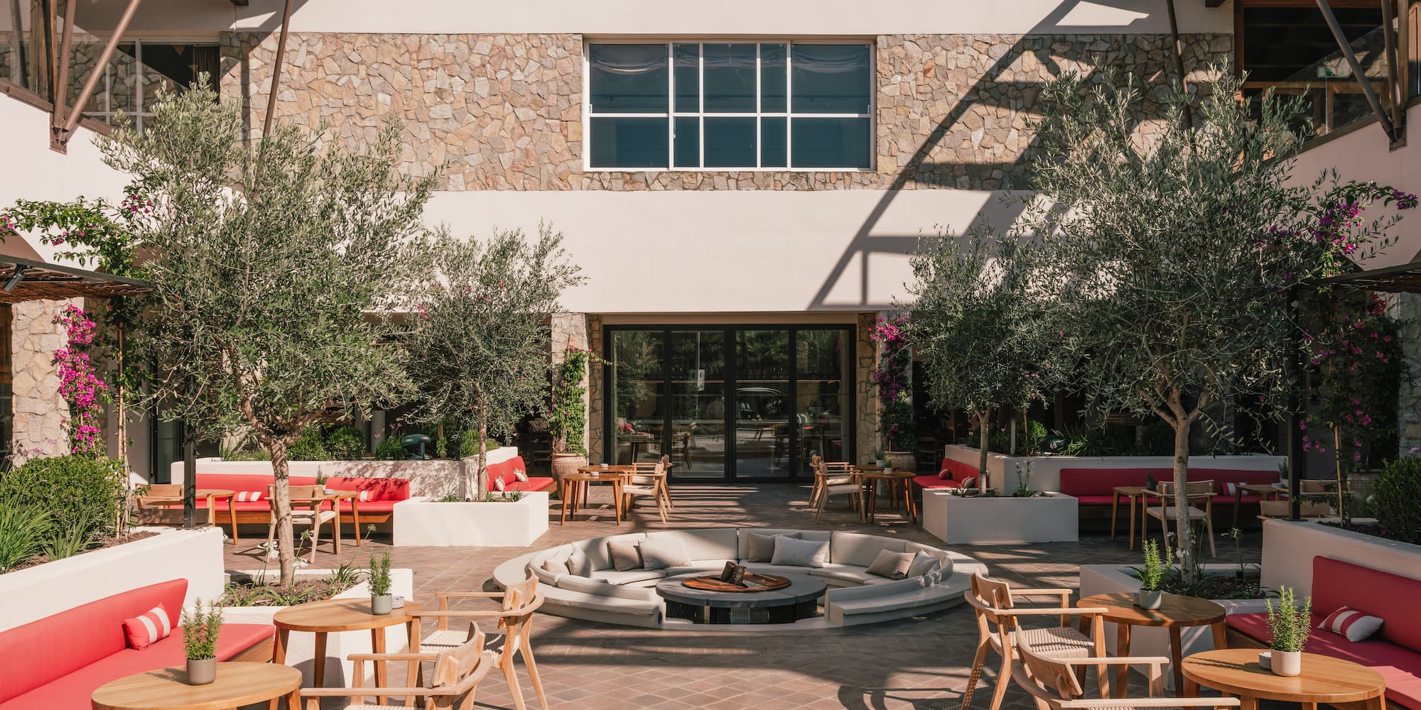 a patio with chairs and tables outside of a building