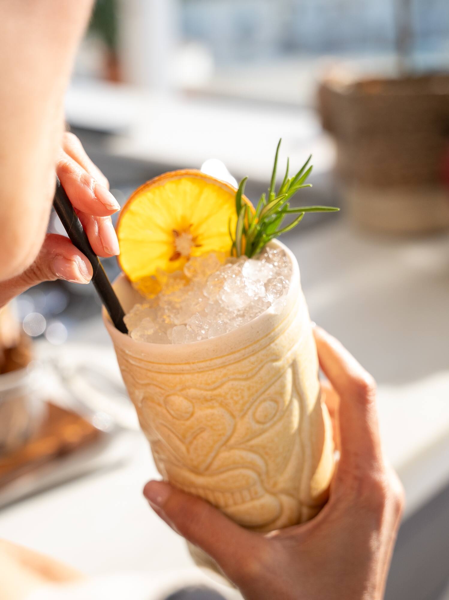 a person holding a drink with a straw