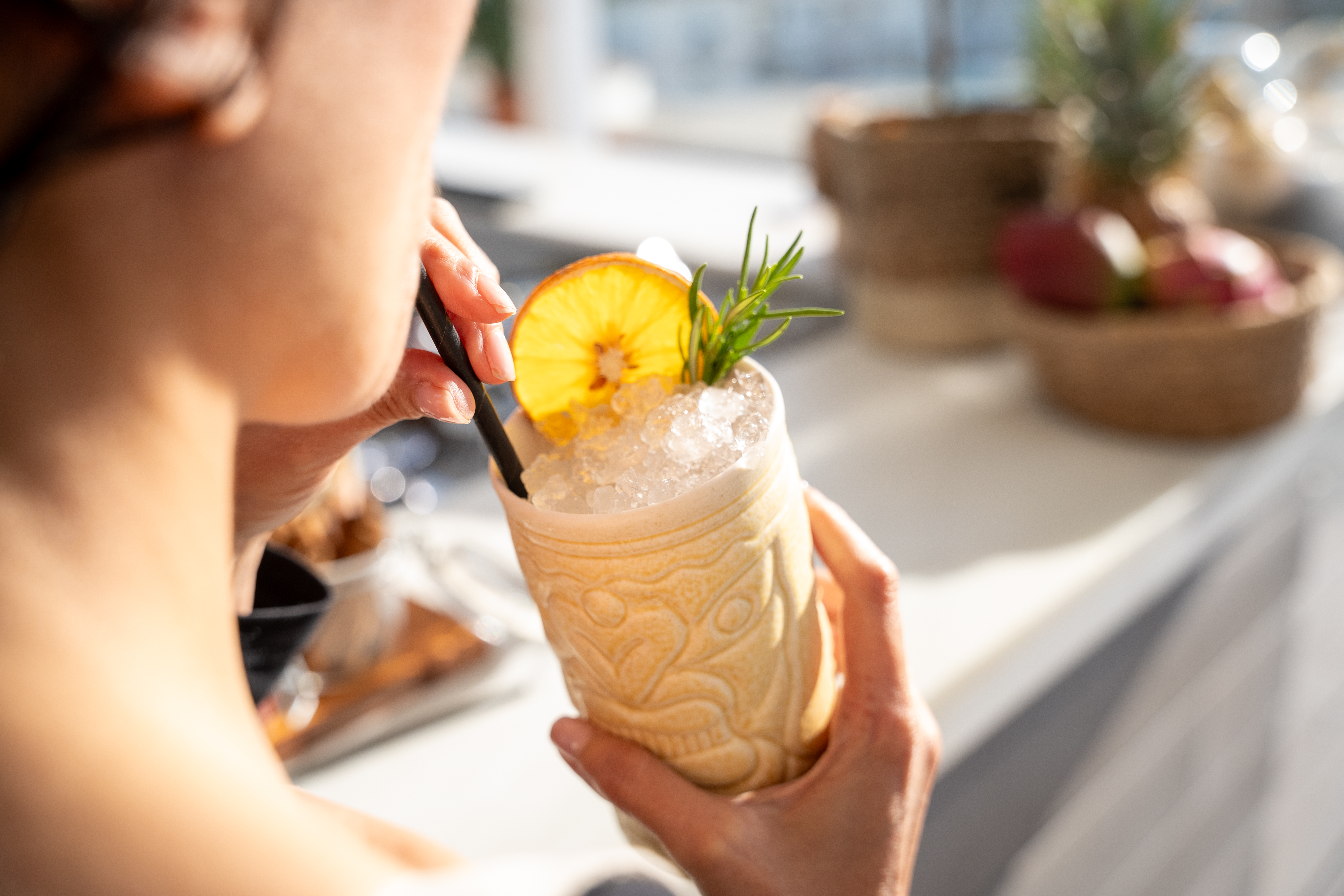 a person holding a drink with a straw