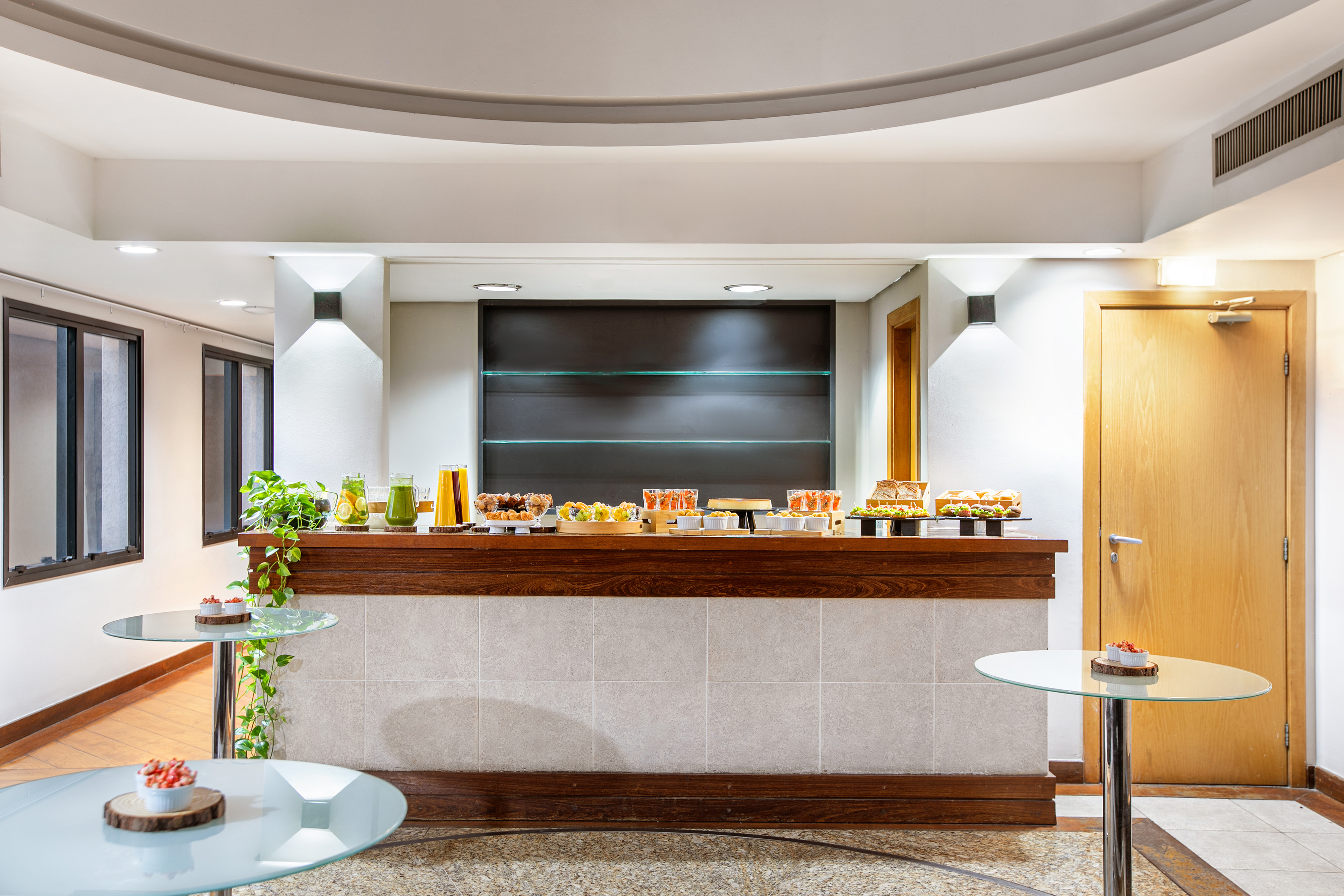 Event catering buffet with fresh juices, sandwiches, and assorted snacks.