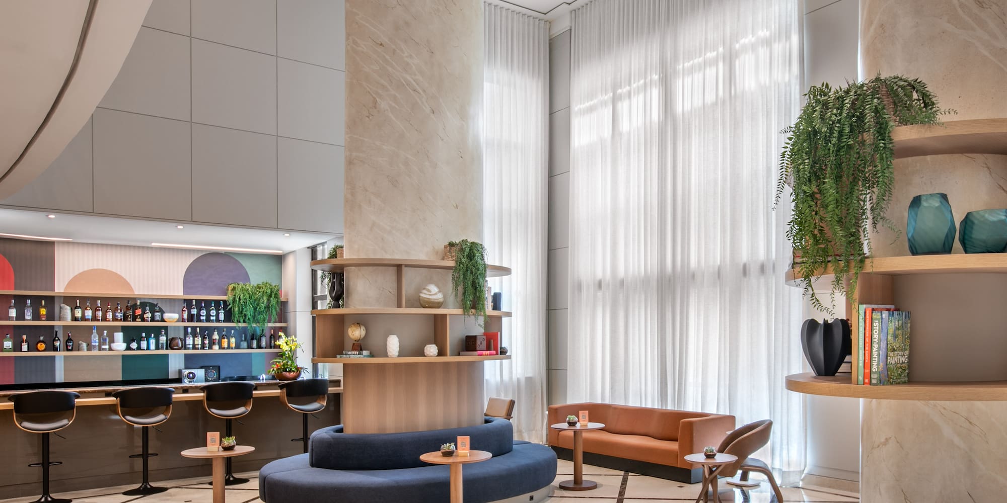 a room with a large column and a round table and chairs