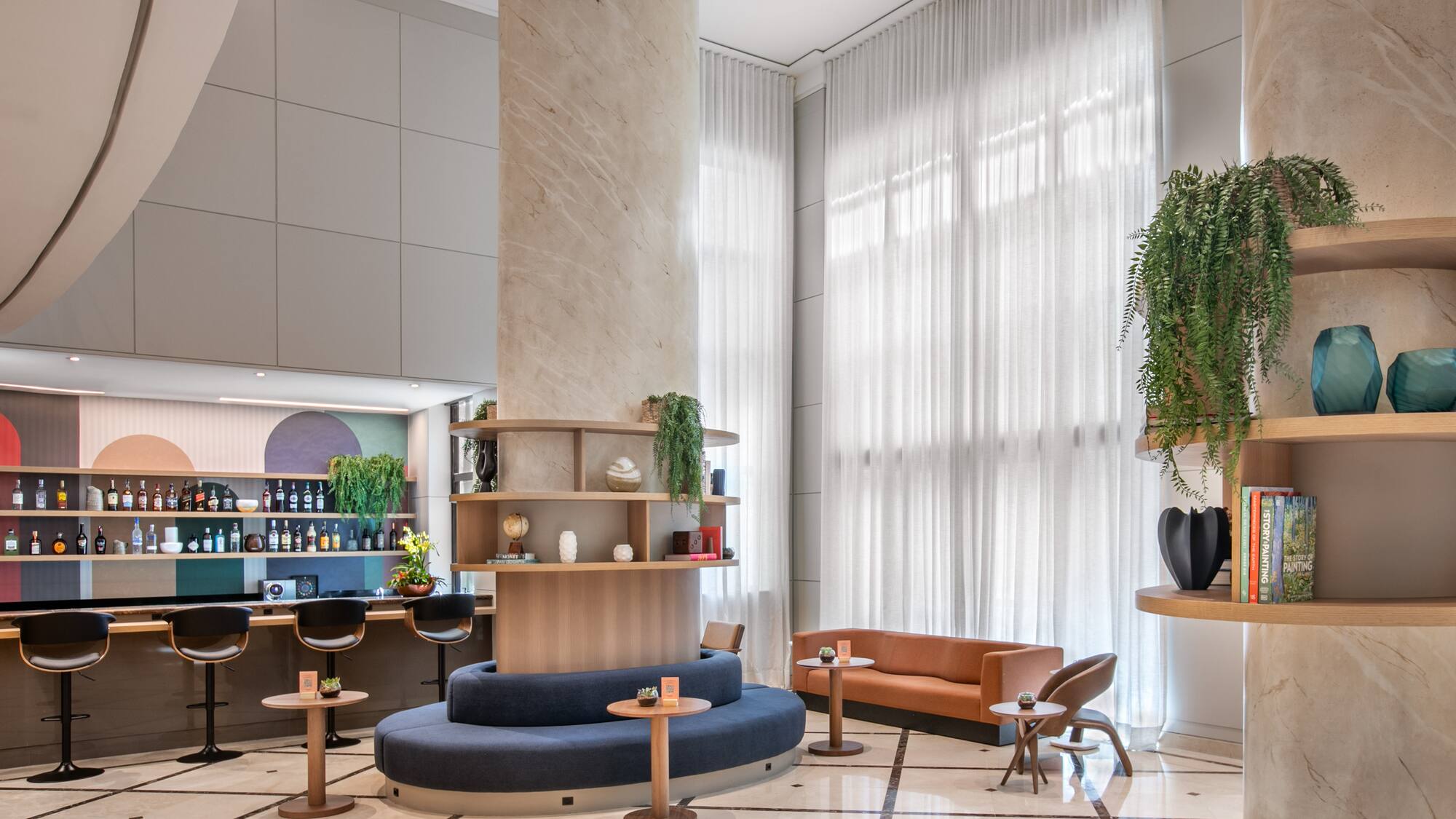 a room with a large column and a round table and chairs