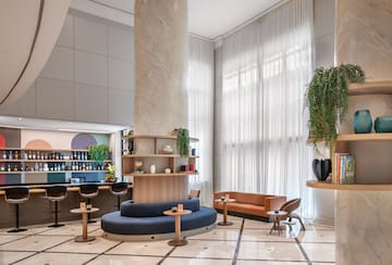 a room with a large column and a round table and chairs