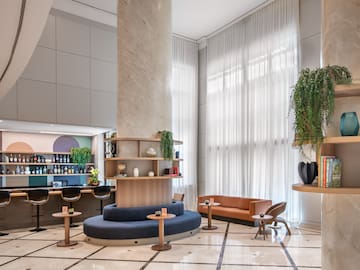 a room with a large column and a round table and chairs