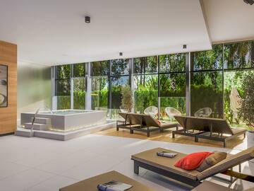 a room with a hot tub and chairs
