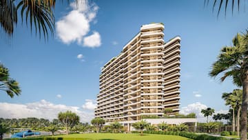 a tall building with trees and grass