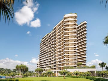 a tall building with trees and grass