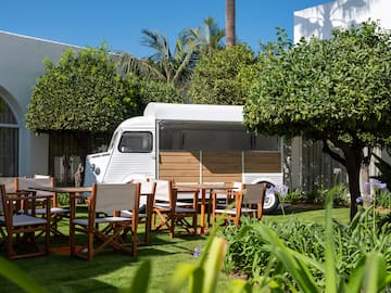 a white van with chairs and tables in a yard
