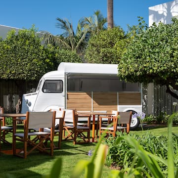 a white van with chairs and tables in a yard