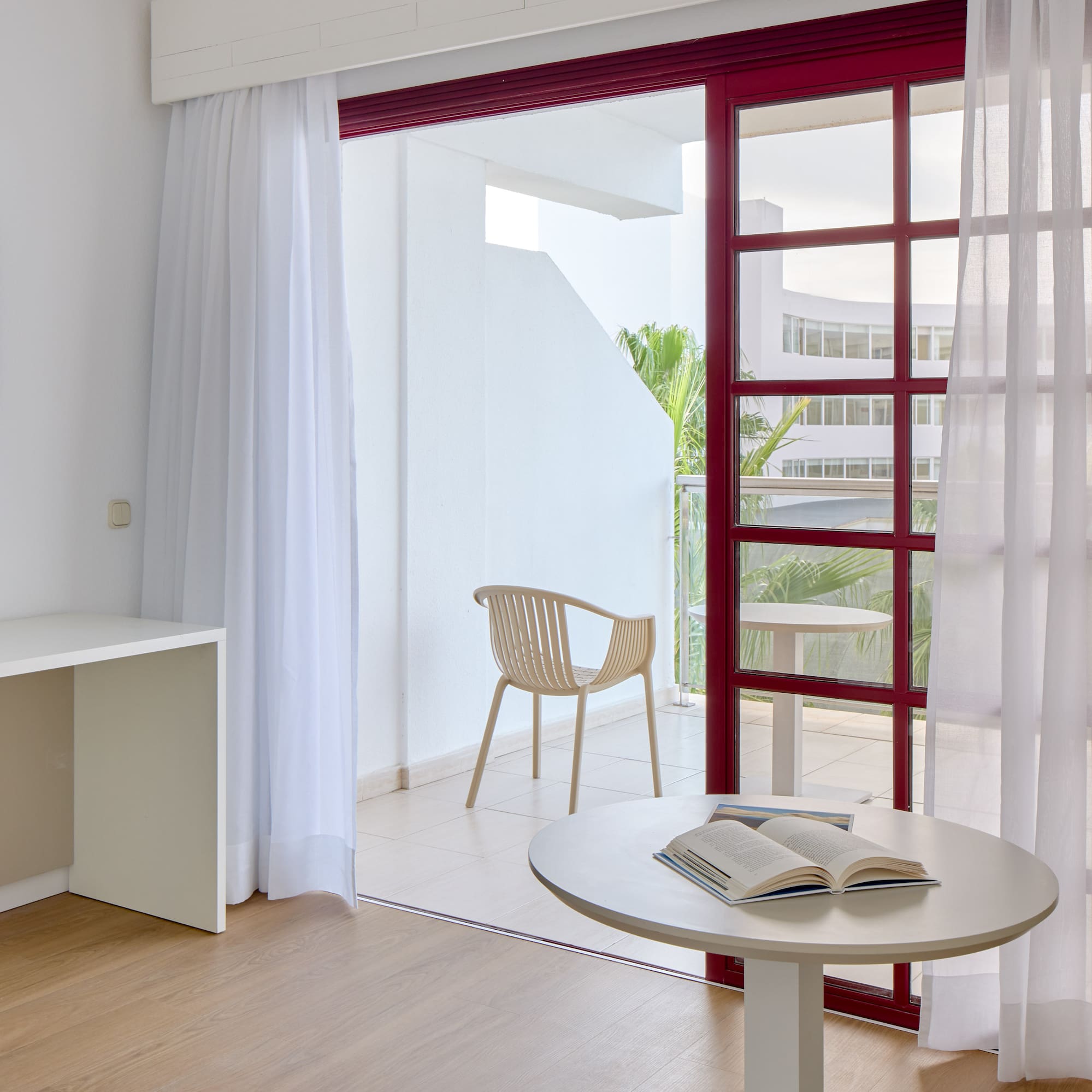 a room with a table and chair and a table with a book