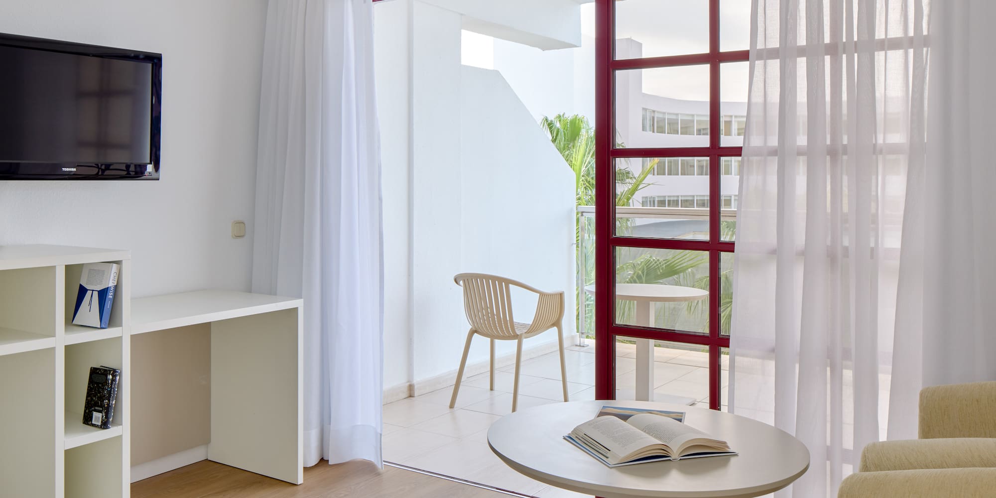 a room with a table and chair and a table with a book