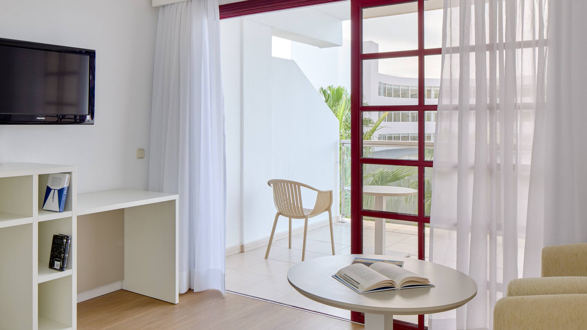 a room with a table and chair and a table with a book