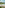 Tropical resort pool lounge with river view, palm trees, and boats.