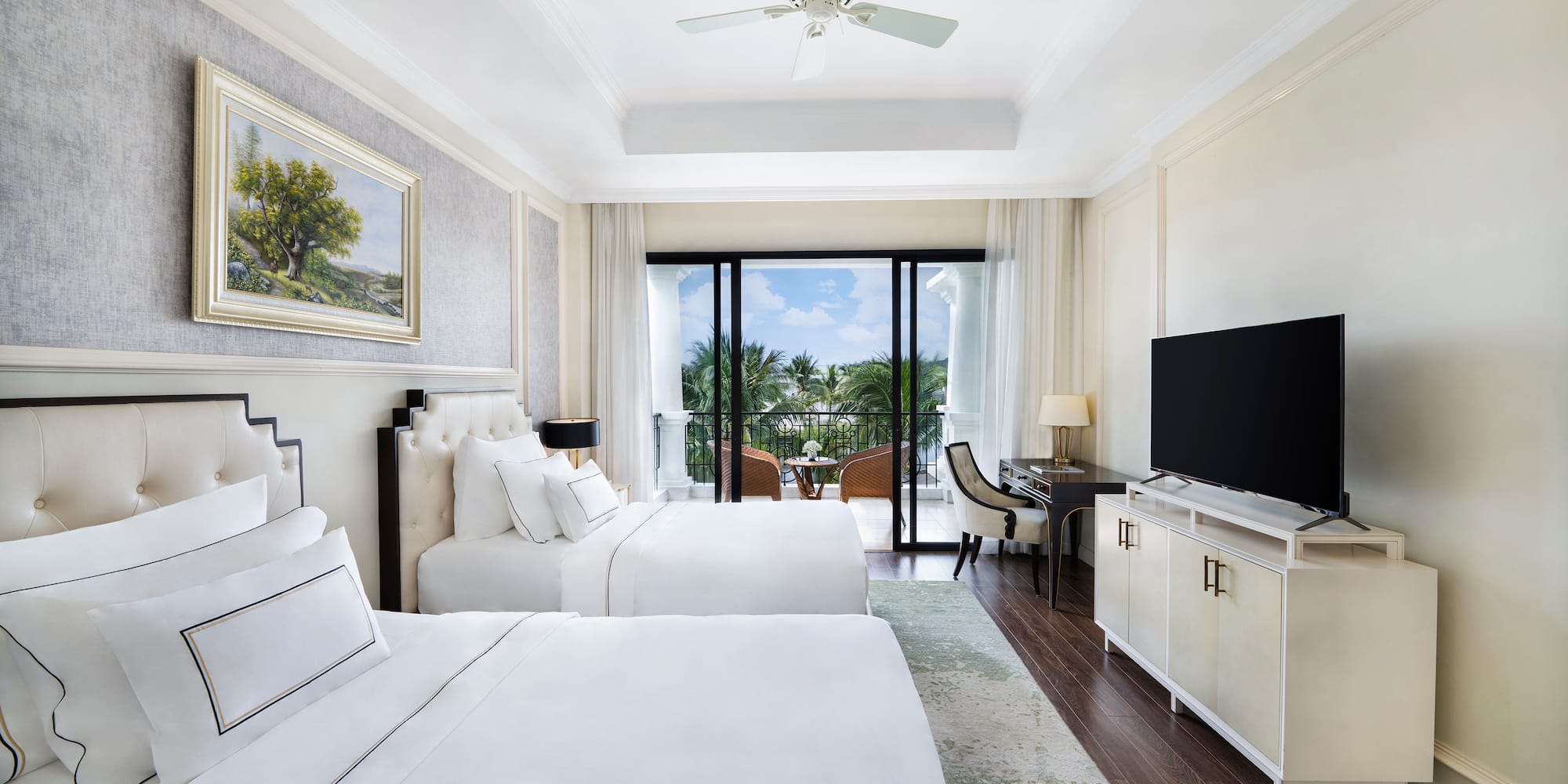 a room with two beds and a television