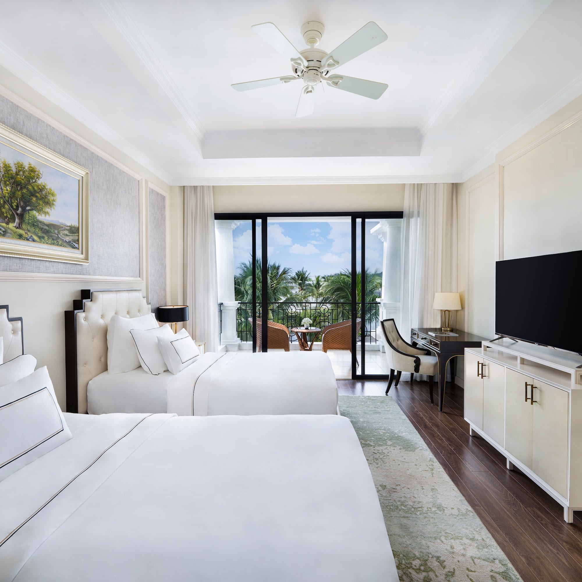 a room with two beds and a television