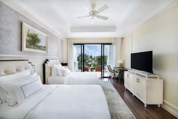 a room with two beds and a television