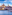 Valletta, Malta cityscape from water, with sailing boat, dome, and spire.