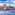 Valletta, Malta cityscape from water, with sailing boat, dome, and spire.