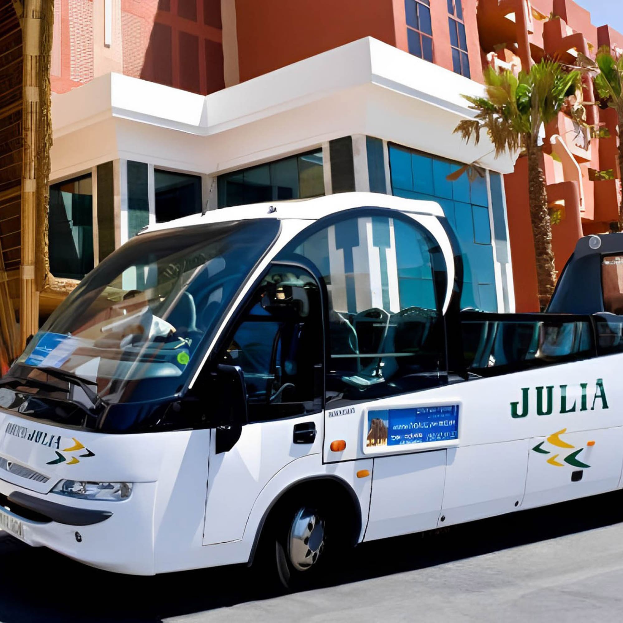 a white bus parked in front of a building