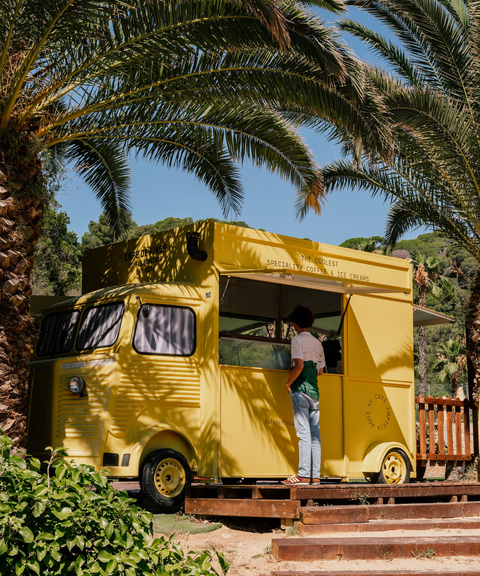 a woman standing in front of a food truck