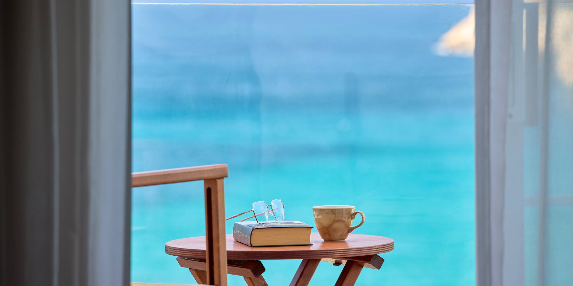 a table with a book and a cup on it