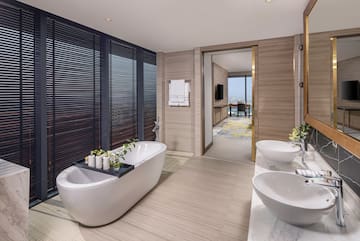 a bathroom with a tub and sinks