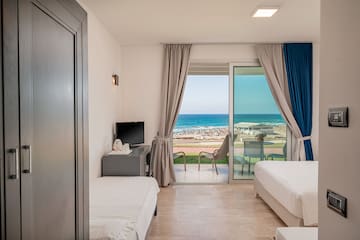 a room with two beds and a sliding glass door