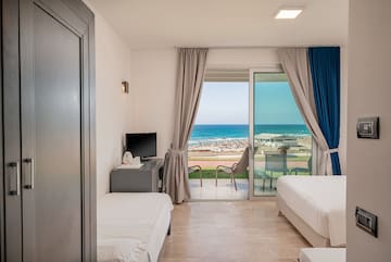 a room with two beds and a sliding glass door