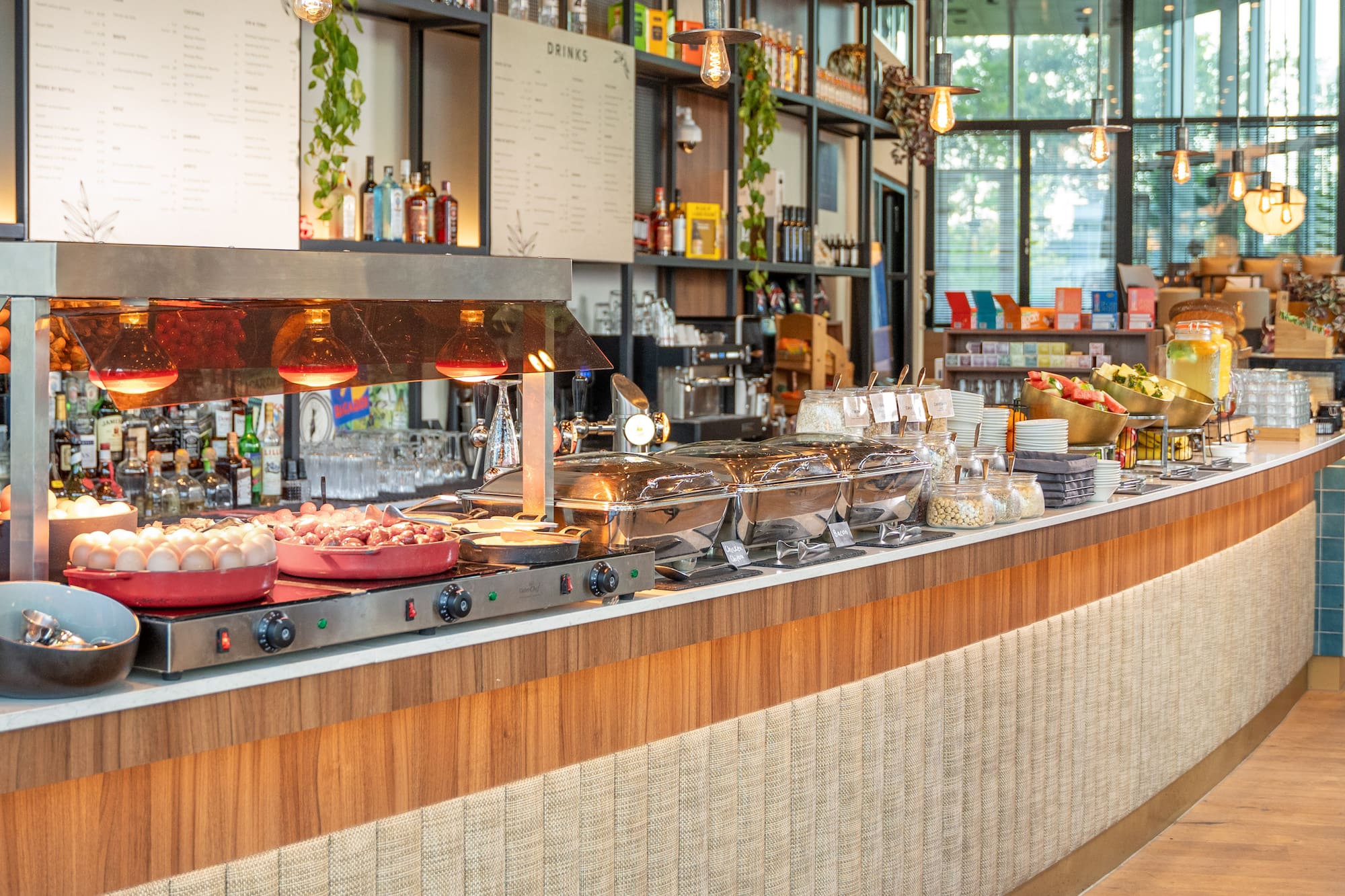 Restaurant breakfast buffet with hot food, fresh fruit, eggs, and cereals.