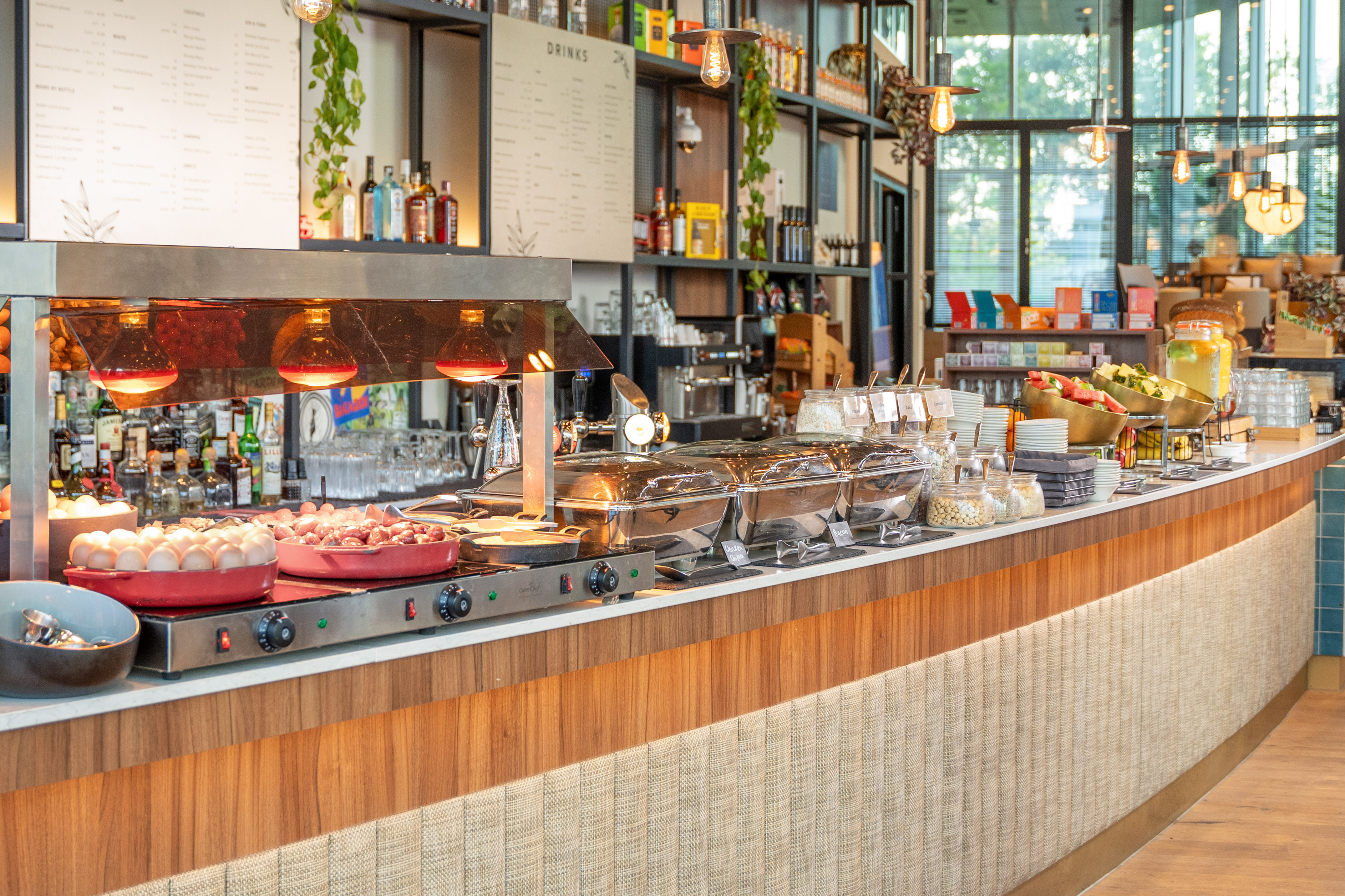 Restaurant breakfast buffet with hot food, fresh fruit, eggs, and cereals.