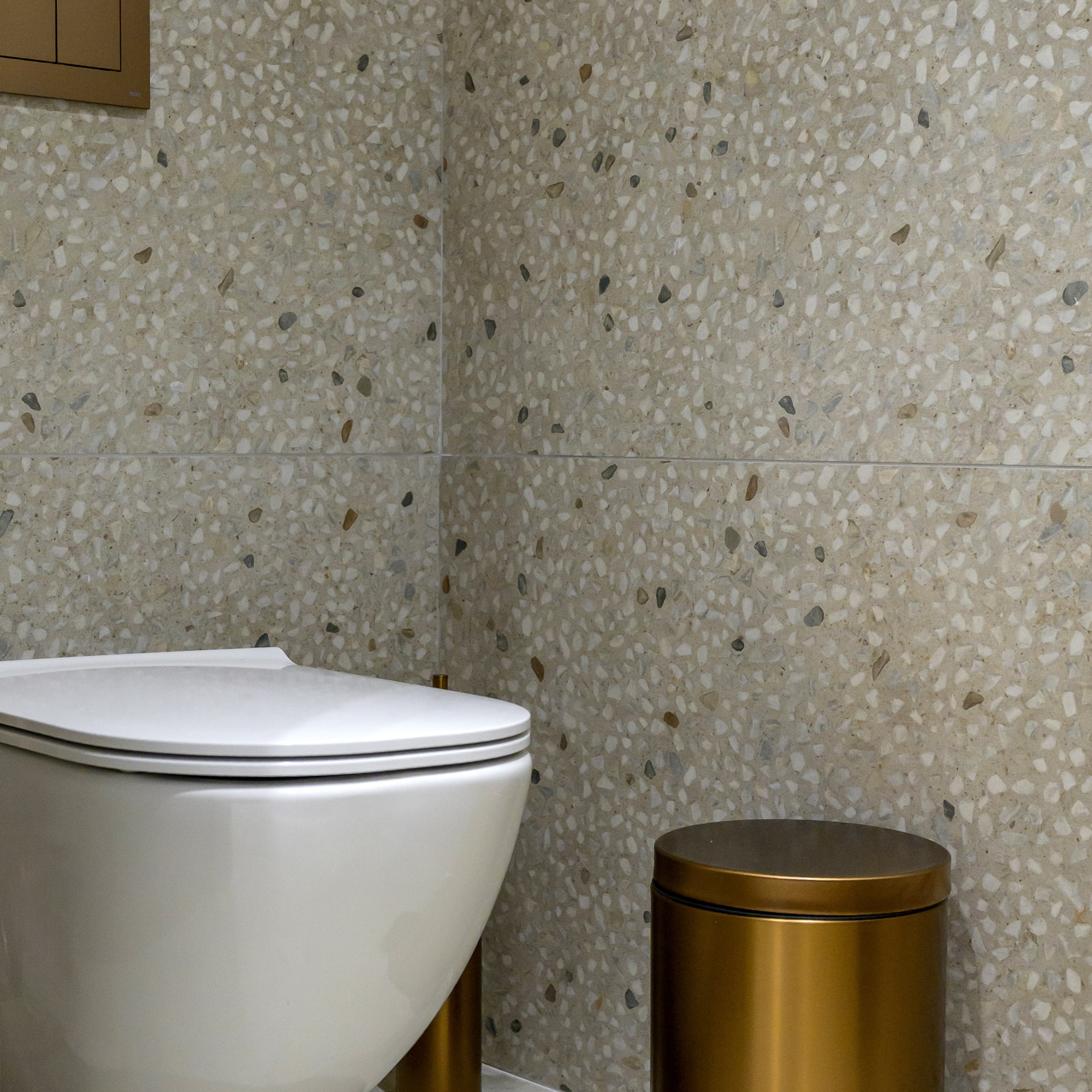 a toilet and trash can in a bathroom