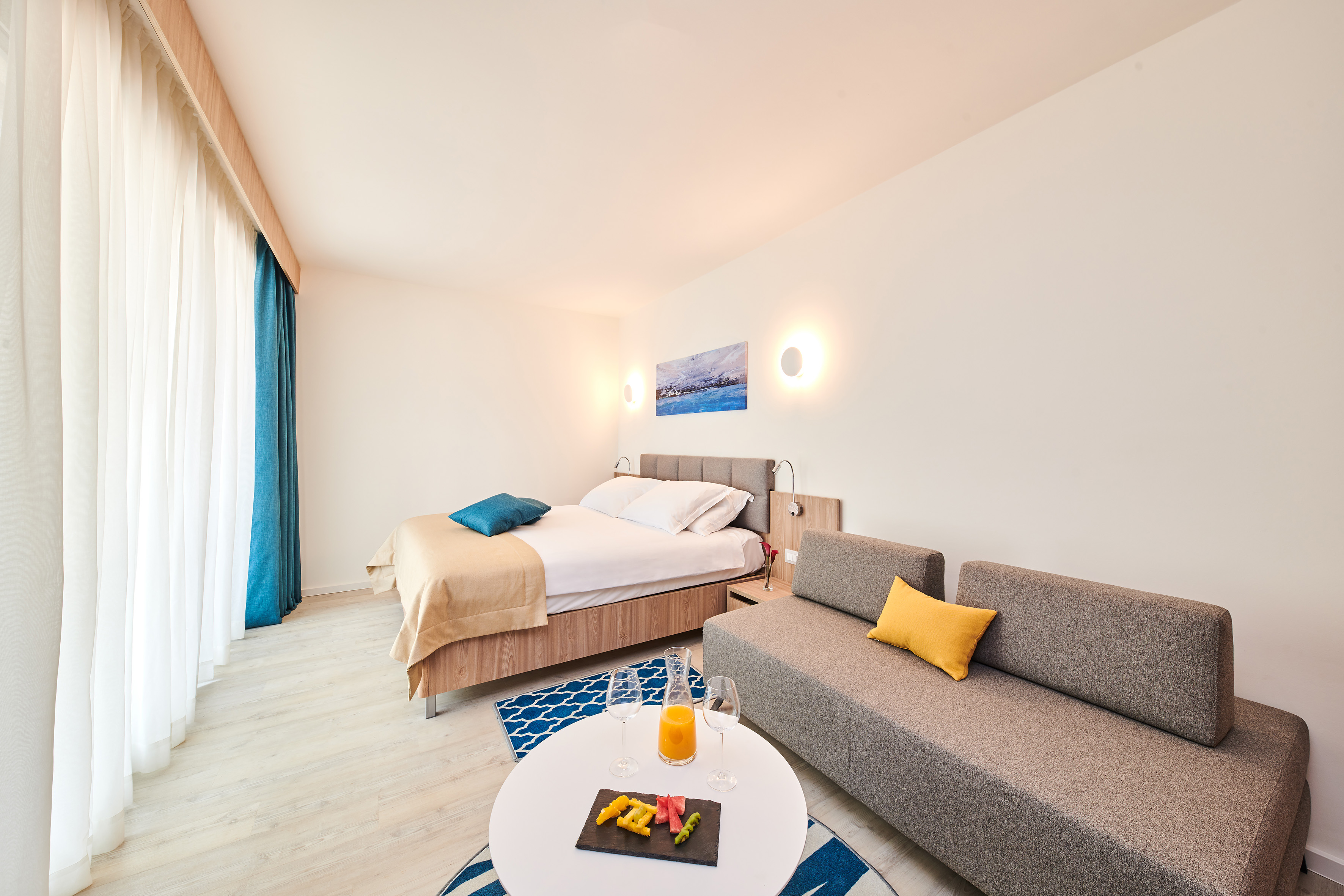 a room with a bed and a couch - Family Room - Garden Suites Umag Plava Laguna Affiliated by Meliá, Umag